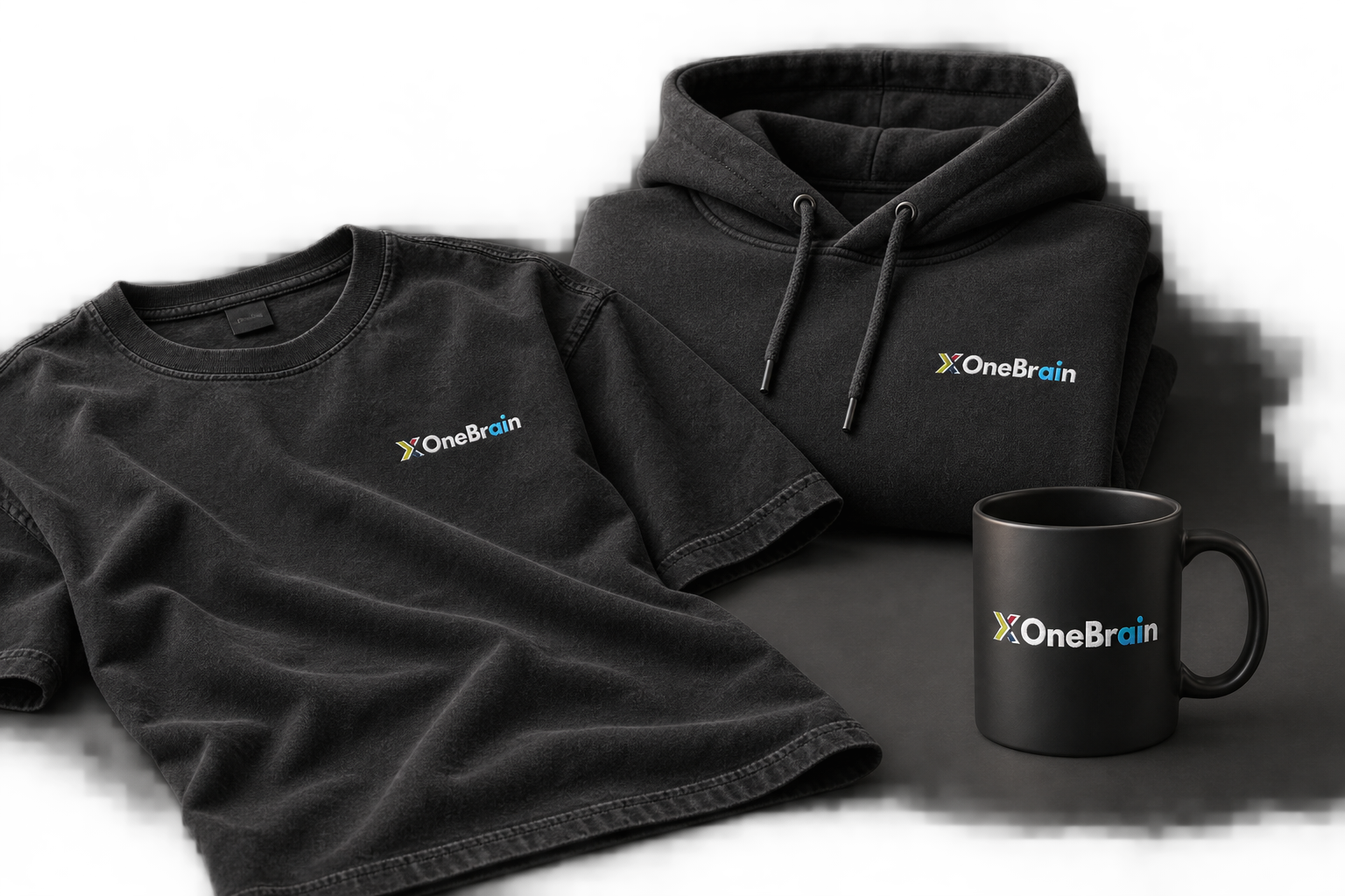 OneBrain merchandise concept: a black T-shirt, charcoal hoodie and black mug with OneBrain branding
